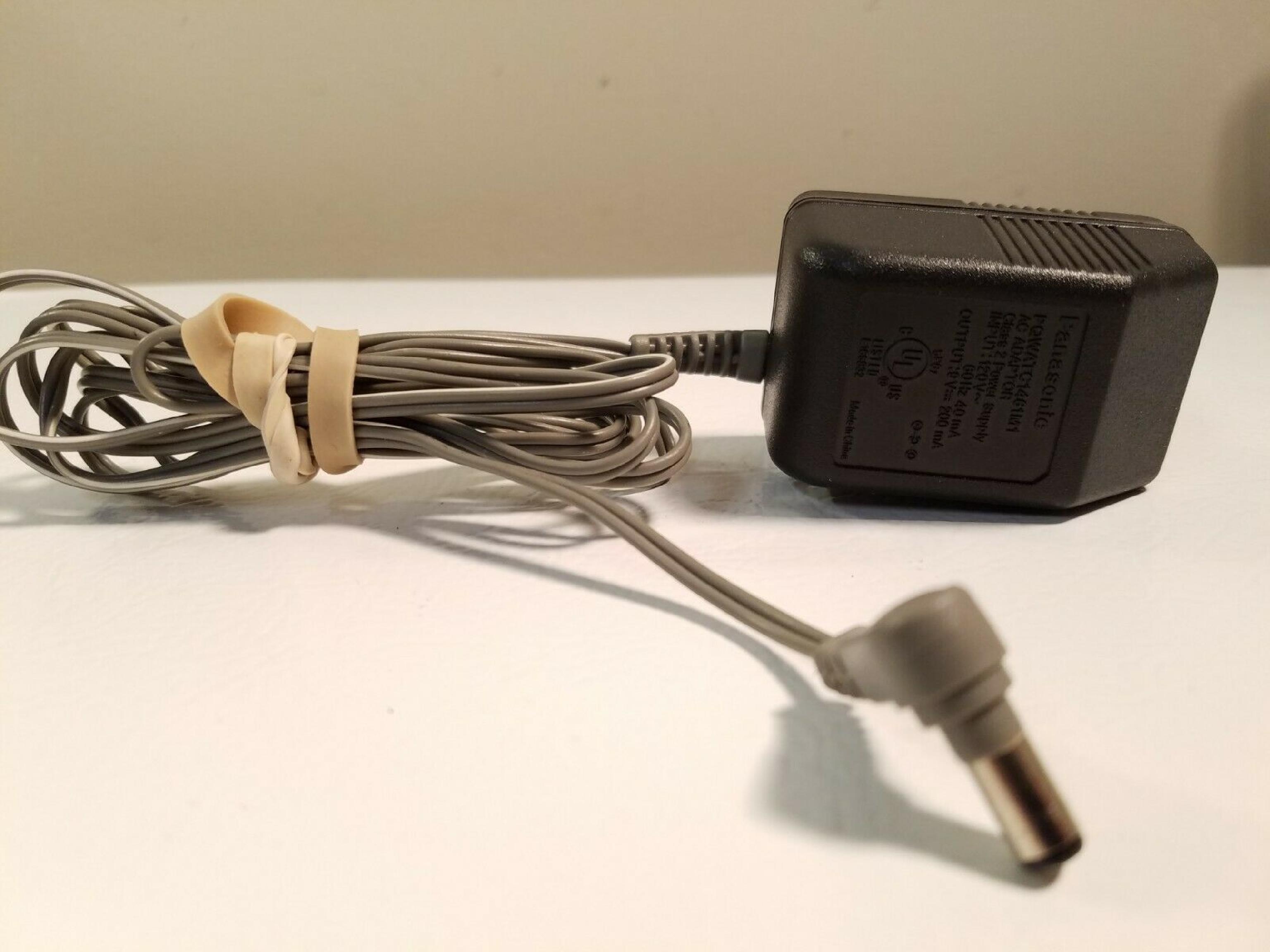 PANASONIC PQWATC1461M1 AC ADAPTER 9VDC 200MA, 6FT CABLE WITH BARREL CONNECTOR, OD:5.5MM, ID:2.15MM, WALL STYLE, NEGATIVE INSIDE POLE